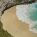 Pemandangan pasir putih dan air laut biru jernih di salah satu destinasi wisata pantai terbaik Indonesia